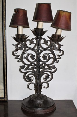 Lot 1560 - Arts and Crafts wrought iron lamp, with three lights and scrolling stem issuing from circular base, 60cm high