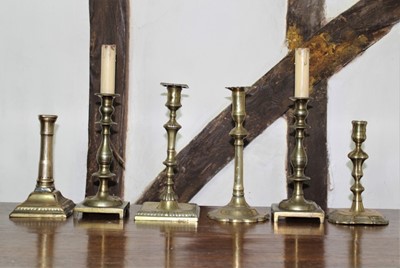 Lot 1570 - Group of 18th/19th century brass candlesticks, to include Queen Anne stick on shaped square base, 18cm high 6 in total