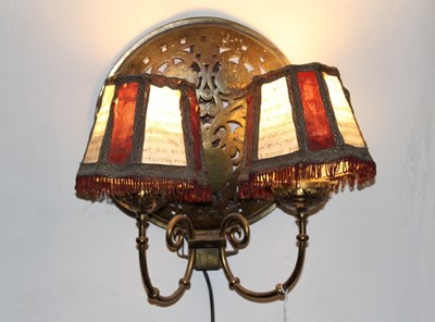 Lot 393 - Pair of brass twin branch wall lights, each with domed panel, formed from warming pan covers
