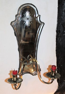 Lot 1627 - Set of four 19th century Continental mirrored glass girandoles, each of cartouche form, bevelled plate with starburst cutting, with twin brass candle arms below