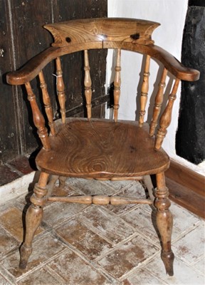 Lot 1629 - Victorian ash and elm smokers bow elbow chair with saddle seat on turned legs and H-shaped stretcher