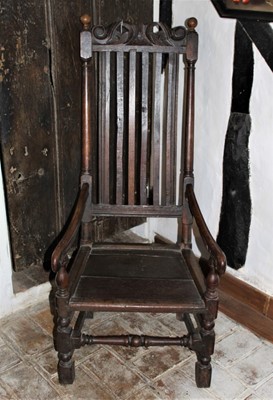 Lot 1632 - 17th century oak open arm chair with pierced top rail and vertical slat back. Panel seat, on turned and block understructure