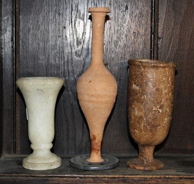 Lot 1655 - Carved alabaster goblet, possibly ancient, 16cm high, together with a carved white alabaster vessel and a Roman ceramic vase (3)