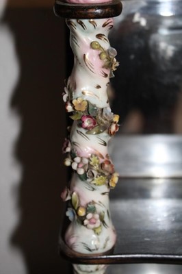 Lot 1656 - Antique wall hanging shelves with mirrored back and mahogany shaped shelves between porcelain floral encrusted spiral turned columns, 24cm wide x 35cm high