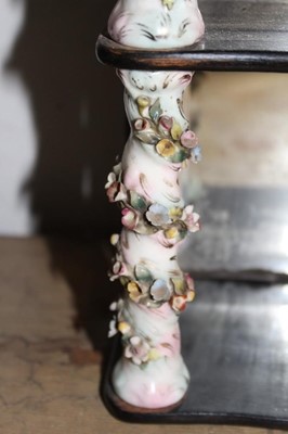 Lot 1656 - Antique wall hanging shelves with mirrored back and mahogany shaped shelves between porcelain floral encrusted spiral turned columns, 24cm wide x 35cm high