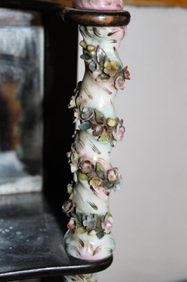 Lot 1656 - Antique wall hanging shelves with mirrored back and mahogany shaped shelves between porcelain floral encrusted spiral turned columns, 24cm wide x 35cm high