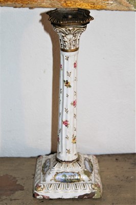 Lot 1660 - 18th century enamelled candlestick with removable brass sconce, fluted column decorated with floral sprigs and landscape reserves, on square base, 30cm high