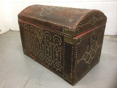 Lot 1673 - Antique leather and metal stud mounted domed trunk with hinged lid and flanking carrying handles, 67cm wide