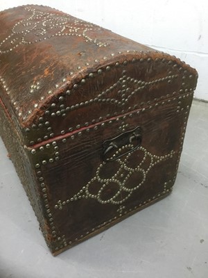 Lot 1673 - Antique leather and metal stud mounted domed trunk with hinged lid and flanking carrying handles, 67cm wide