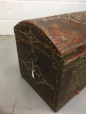 Lot 1673 - Antique leather and metal stud mounted domed trunk with hinged lid and flanking carrying handles, 67cm wide