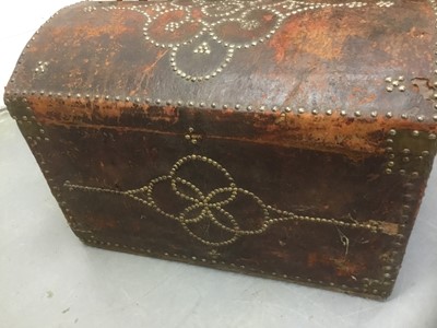 Lot 1673 - Antique leather and metal stud mounted domed trunk with hinged lid and flanking carrying handles, 67cm wide