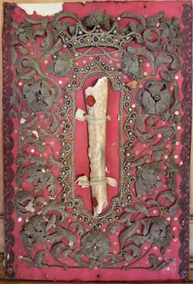 Lot 1693 - 18th/19th century Continental relic, the central bone with wax seals within a metal thread woven border, mounted on puce fabric ground and board backing, total size 47cm x 32cm