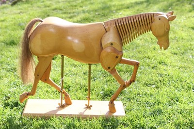 Lot 1700 - Artists articulated wooden model of a horse, on rectangular plinth, 55cm long overall