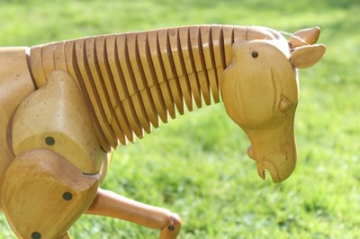 Lot 1700 - Artists articulated wooden model of a horse, on rectangular plinth, 55cm long overall