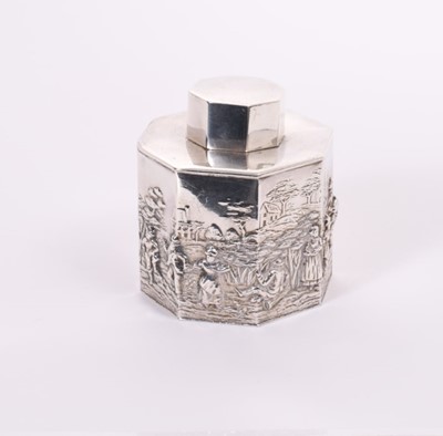 Lot 352 - George V silver tea caddy of octagonal form with embossed Dutch style figural decoration landscape, with slip on cover, (Chester 1912), makers mark rubbed approximately 6oz, 8.5cm in height