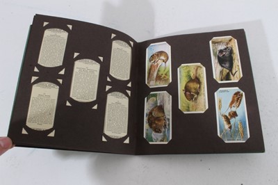 Lot 153 - Cigarette cards - Seven old albums, containing a selection of sets, part sets and odd cards.