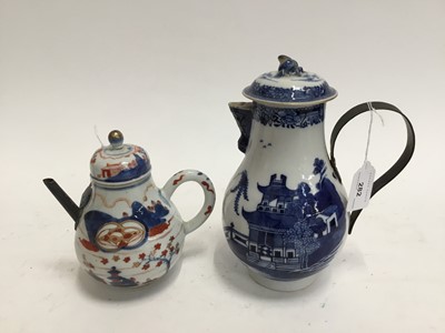 Lot 282 - 18th century Chinese export blue and white coffee pot with iron strap-work handle, 23cm high, together with a 18th century Imari pot and cover with replacement spout, 17cm high (2)