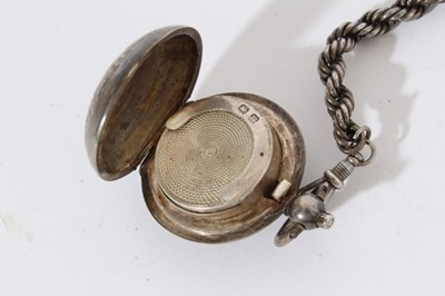 Lot 437 - Edwardian silver sovereign case of domed circular form with engraved decoration and gilded interior, (Birmingham 1907), together with a George V silver sovereign holder (Birmingham 1911)