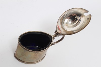 Lot 436 - Late Victorian Arts & Crafts silver mustard pot with domed hinged cover and blue glass liner (Birmingham 1899), maker Liberty & Co