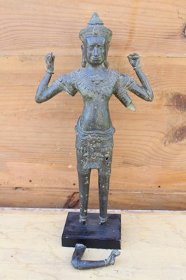 Lot 1765 - Early Thai bronze standing figure of a four armed deity, 37cm high, presented on a square base