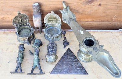 Lot 1777 - Indian brass oil lamp of typical boat form, 41cm, together with two Tibetan brass shrines, curious triangular scrip inscribed plaque, two African bronze figures and other items