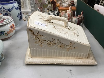 Lot 215 - Victorian pottery cheese dish, four Staffordshire cow creamers and two figures (7)