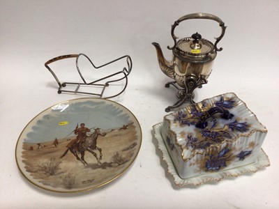 Lot 674 - Victorian plated spirit kettle on stand, plated wine bottle holder, a commemorative 'American West' dish and a large Carlton Ware cheese dish (4)