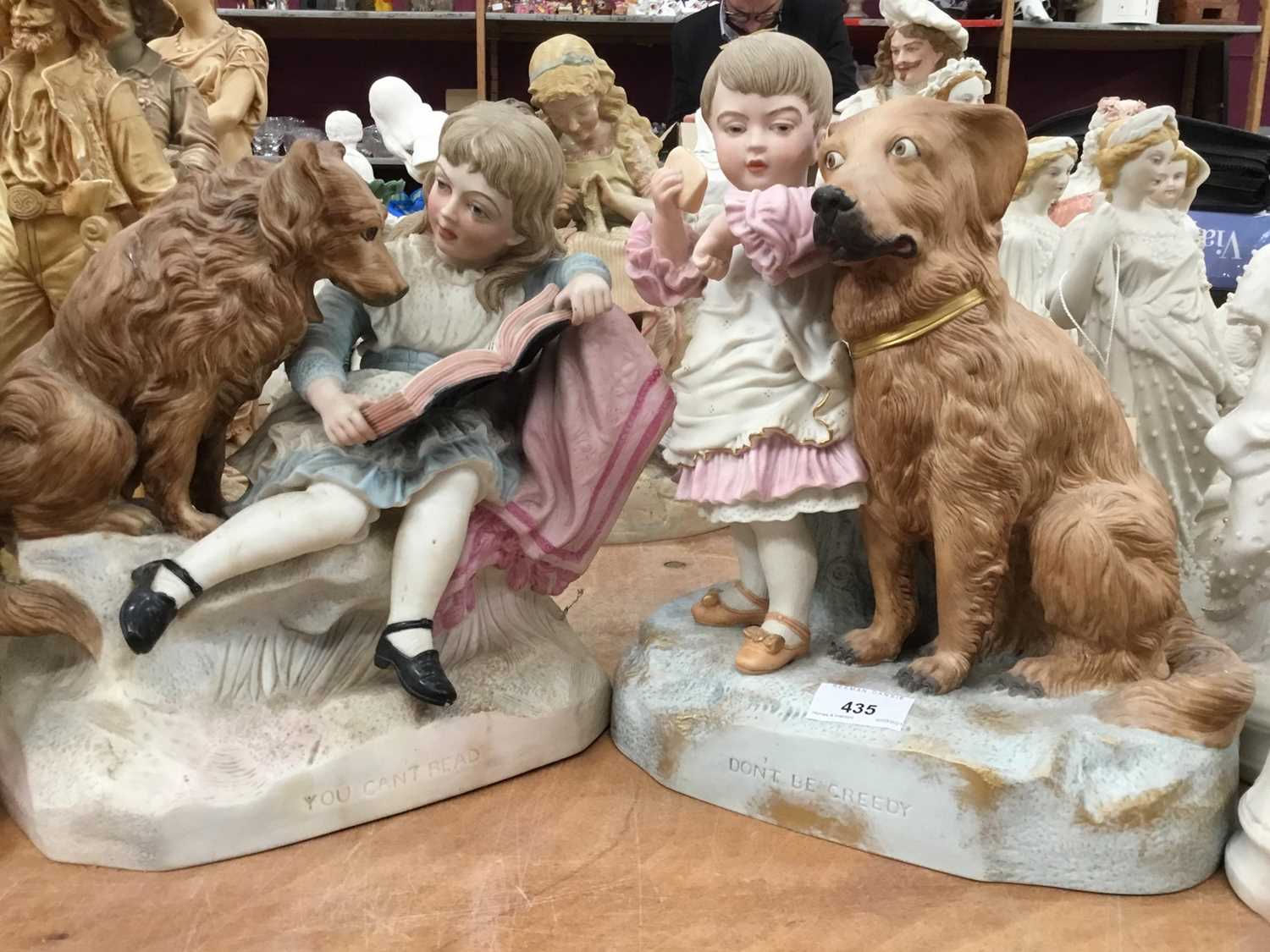 Lot 435 - Four Victorian polychrome Parian porcelain figure group with dogs and children