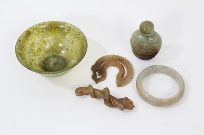 Lot 814 - Small collection of Chinese jade, including a spinach jade bowl, a snuff bottle, a bangle, a toggle and a buckle (5)