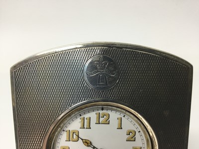 Lot 551 - 1920s silver pocket watch holder with engine turned decoration and engraved crest, with leather covered easel back (London 1923) and stainless steel pocket watch with luminous numbers, 12.5cm high...