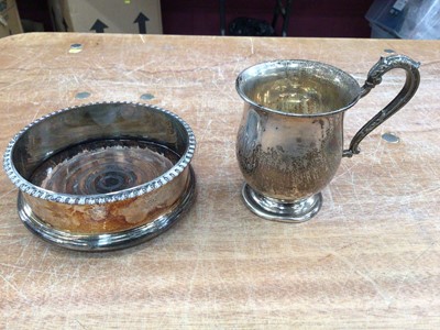 Lot 589 - Sterling silver Christening mug, Birmingham 1930, with scrollwork handle, and a plated coaster (2)