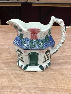 Lot 133 - Staffordshire pearlware jug, c.1800, moulded in the form of a cottage and painted in enamels, 12cm height