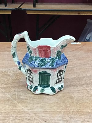 Lot 133 - Staffordshire pearlware jug, c.1800, moulded in the form of a cottage and painted in enamels, 12cm height