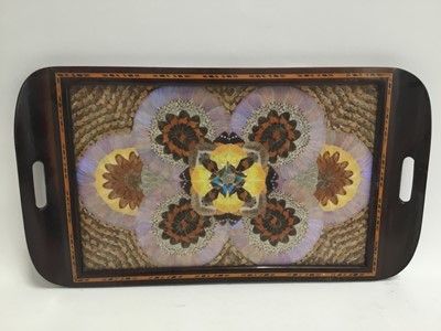 Lot 577 - Wooden tray containing a glazed display of preserved butterfly wings together with three resin Buddha/deity figures and a ceramic cockatoo