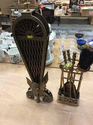 Lot 607 - Brass fan fire screen with gargoyle decoration, and a set of brass fire tools