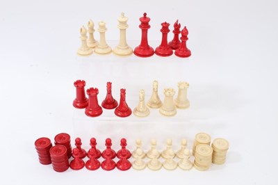 Lot 830 - Fine 19th century Jaques, Staunton pattern, white and red stained ivory chess set, white king stamped on base “Jaques London” and one of each, red and white castles, with crown. Together with a mat...