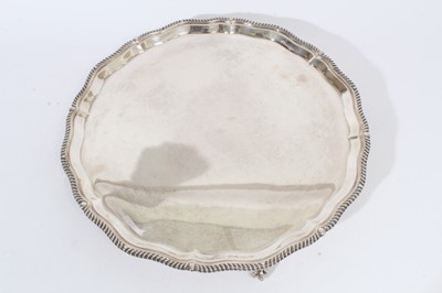 Lot 353 - A large, fine quality, 1930s silver salver of circular form with piecrust and gadrooned border, on four ball and claw feet (London 1938) Goldsmiths & Silversmiths Co. Ltd. All at approximately 60 o...