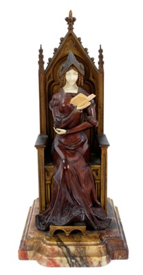 Lot 823 - In the manner of Jean Dampt (1854 - 1945): a late 19th century French Gothic Revival bronze, ivory and rosewood figure of a young woman dressed in medieval costume, seated on a throne reading a boo...