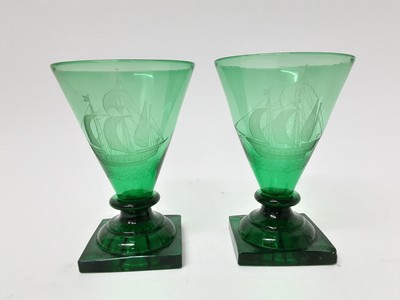 Lot 230 - Pair of antique drinking glasses engraved with tall ships on lemon squeezer feet (2)