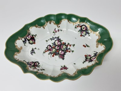 Lot 139 - A Worcester 'spotted fruit' painter green ground dish, circa 1770