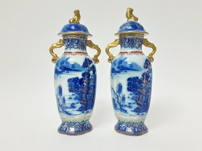 Lot 165 - Pair of early 19th century Masons twin-handled stoneware vases, and covers, decorated in underglaze blue, enamels and gilt with Chinese landscape scenes, pseudo-seal marks to bases, 26cm high