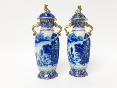 Lot 165 - Pair of early 19th century Masons twin-handled stoneware vases, and covers, decorated in underglaze blue, enamels and gilt with Chinese landscape scenes, pseudo-seal marks to bases, 26cm high