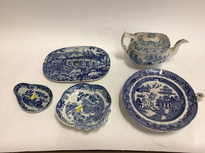 Lot 663 - Small collection of 19th century blue and white transfer ware, including a Willow pattern warming dish, a drainer printed with a rural scene, a Miles Mason teapot,  a shell-shaped dish and an irons...