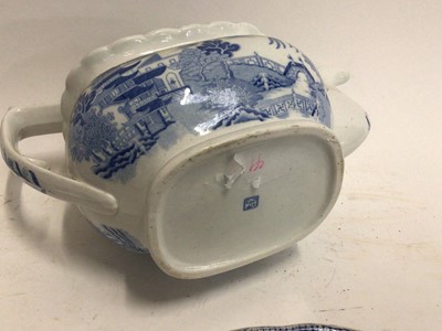 Lot 663 - Small collection of 19th century blue and white transfer ware, including a Willow pattern warming dish, a drainer printed with a rural scene, a Miles Mason teapot,  a shell-shaped dish and an irons...