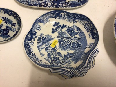 Lot 663 - Small collection of 19th century blue and white transfer ware, including a Willow pattern warming dish, a drainer printed with a rural scene, a Miles Mason teapot,  a shell-shaped dish and an irons...