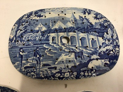 Lot 663 - Small collection of 19th century blue and white transfer ware, including a Willow pattern warming dish, a drainer printed with a rural scene, a Miles Mason teapot,  a shell-shaped dish and an irons...