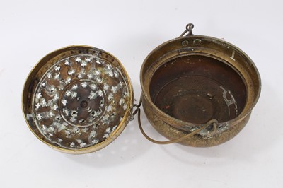 Lot 879 - 17th century brass censer, with pierced domed cover and surmounting cage, the squat vessel with foliate ornament and swing handle, 18cm diameter 
Provenance: Estate of the Late Jane Sumner