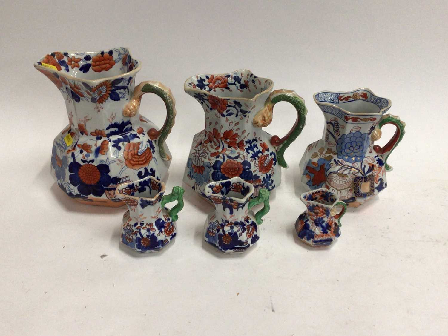 Lot 668 - Six 19th century graduated Masons Ironstone jugs, Imari patterns with serpent handles, the largest 21.5cm high