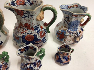 Lot 668 - Six 19th century graduated Masons Ironstone jugs, Imari patterns with serpent handles, the largest 21.5cm high