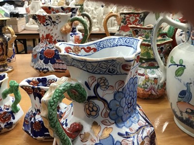 Lot 668 - Six 19th century graduated Masons Ironstone jugs, Imari patterns with serpent handles, the largest 21.5cm high